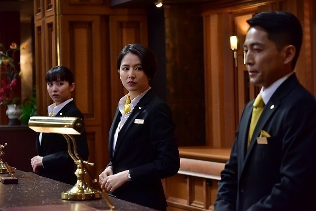 woman and man standing at hotel reception
