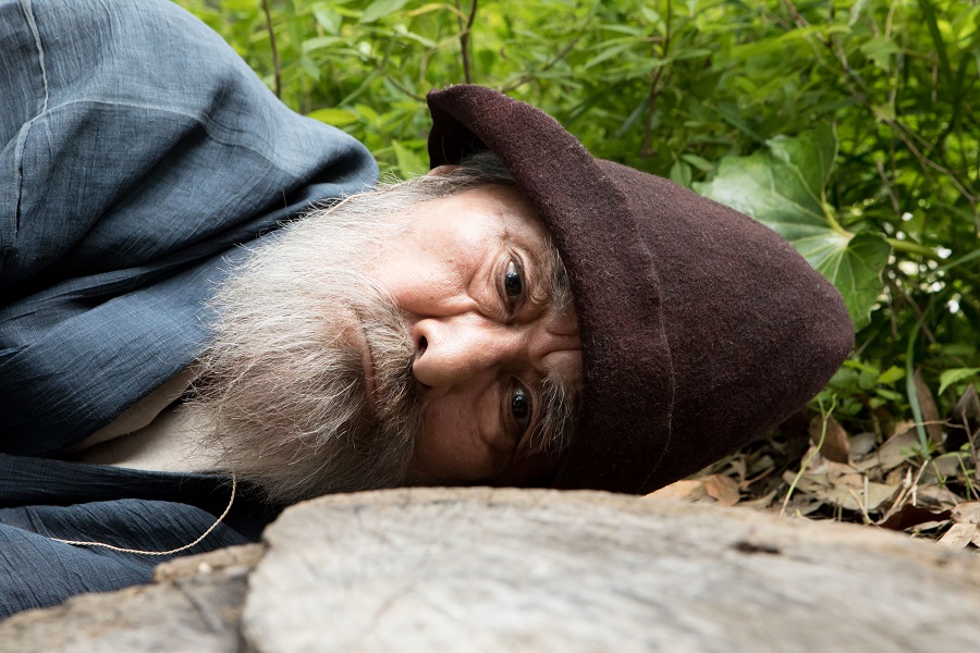 older man with head on rock
