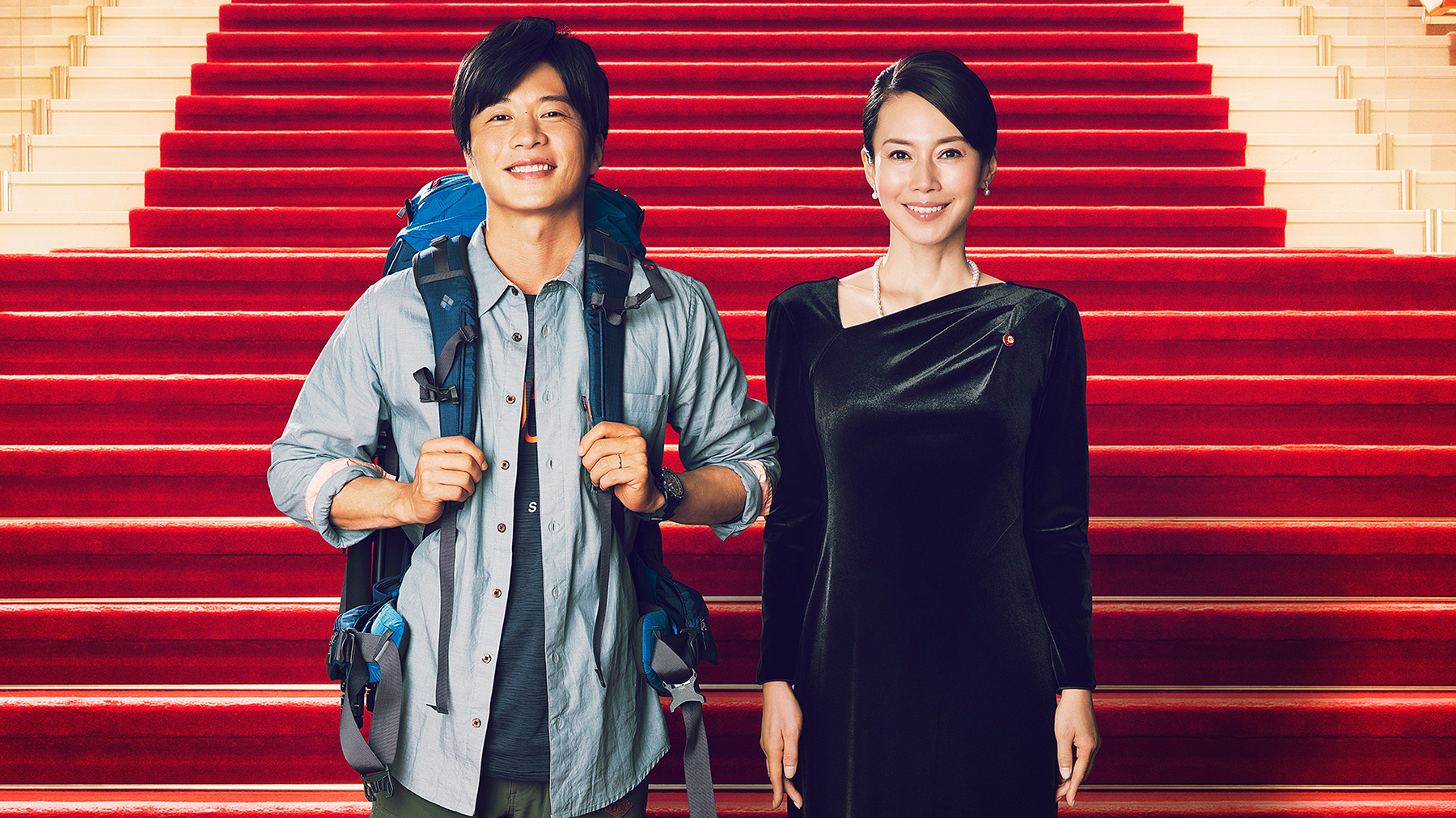 woman and man in front of red stairs