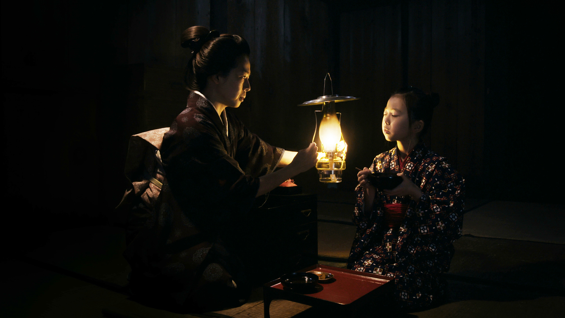 woman holding lantern with child