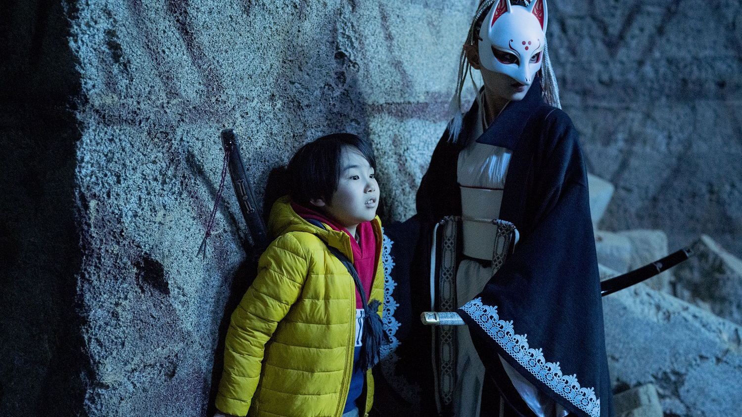 child with masked figure