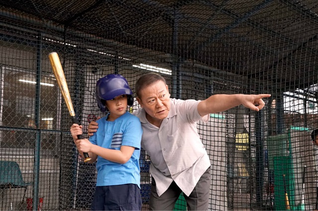 man with grandson playing baseball