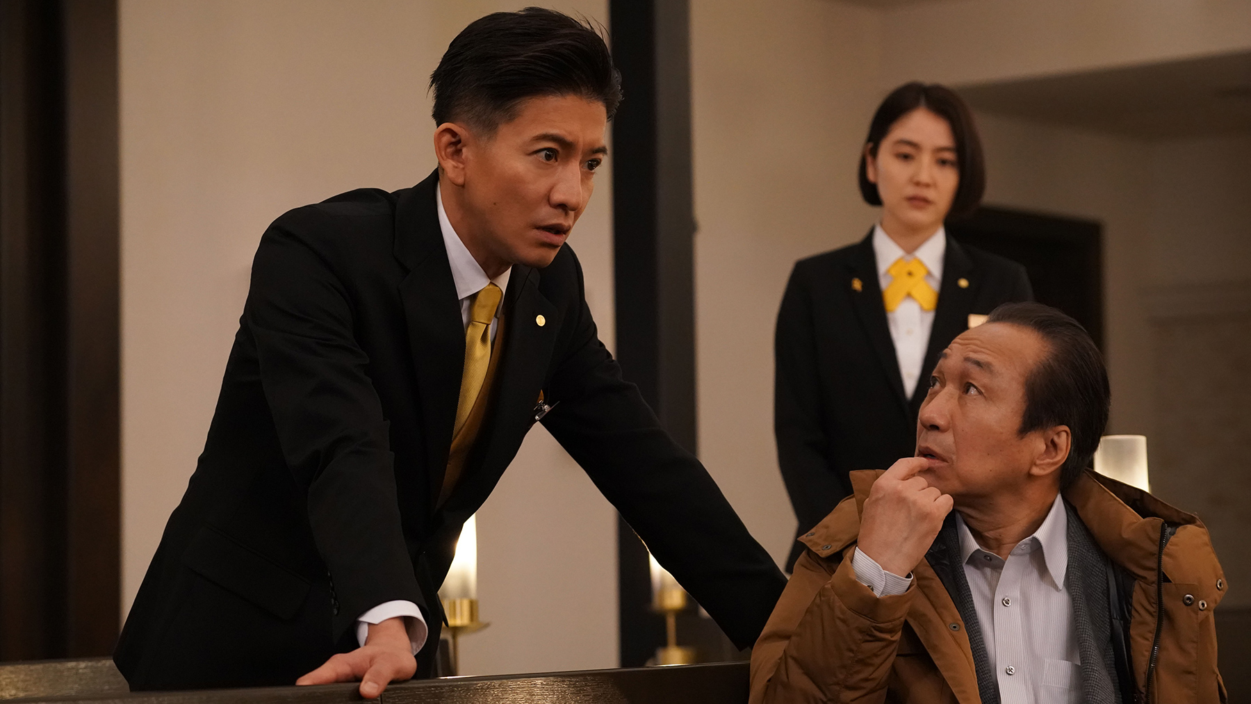 police detective in thought with man sitting down and looking at him