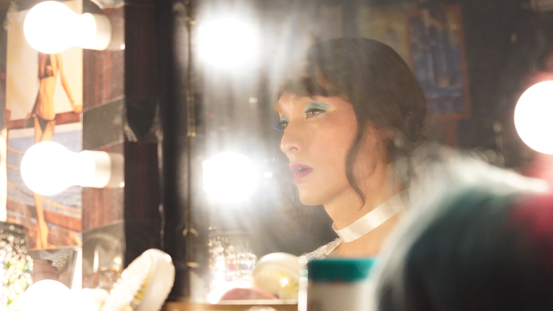 Transgender woman looking in a mirror