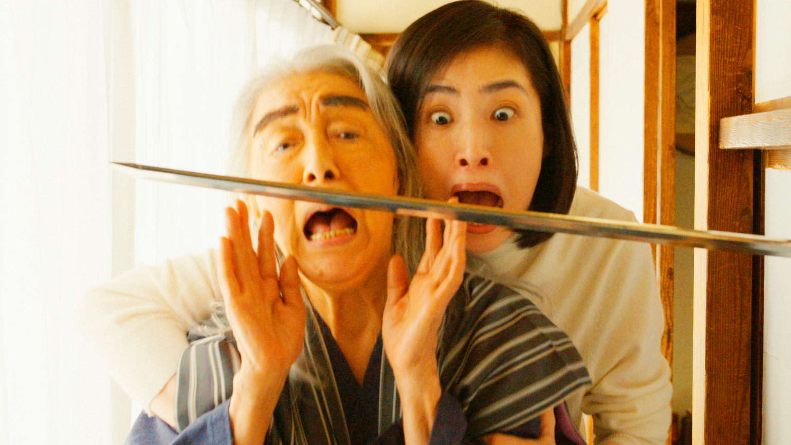 woman and man screaming with sword in front of their face