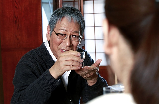 man drinking sake