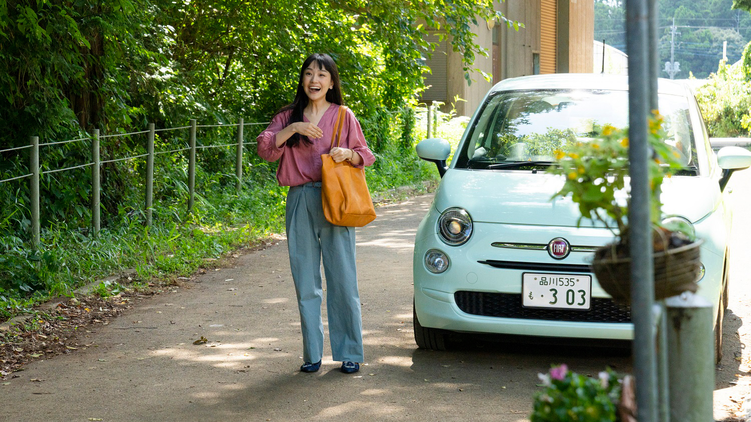 woman standing next to car